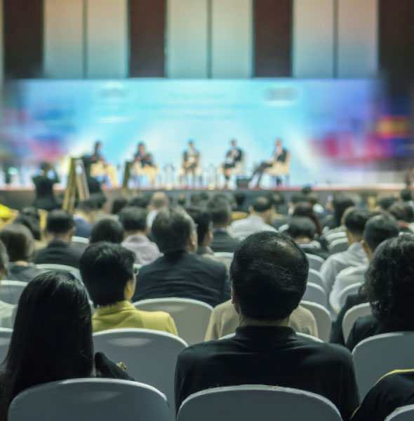 Delegates watching a panel discussion at a biotechnology conference